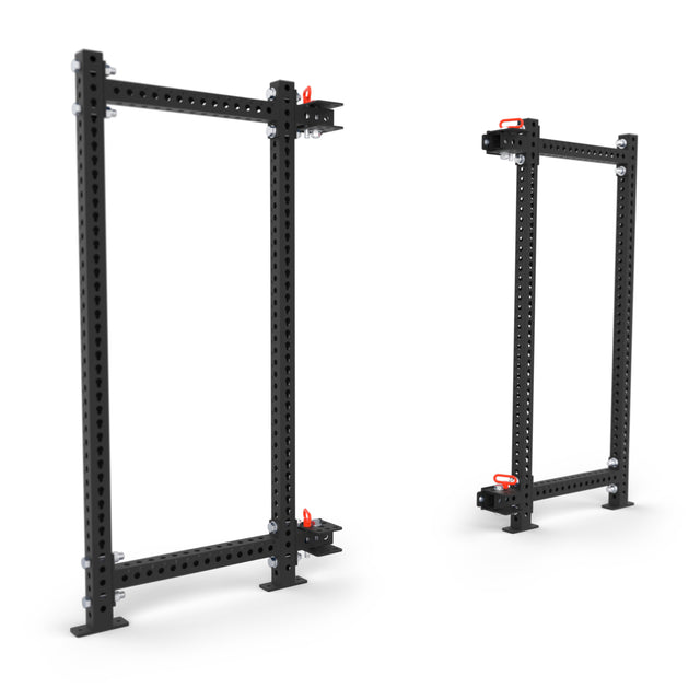 Two Manticore Folding Power Racks by Bells of Steel, featuring 3"x3" uprights and 1" holes, stand separately with red safety locks—ideal for versatile home gym setups. Prebuilt frames provide multiple attachment options against a white background.