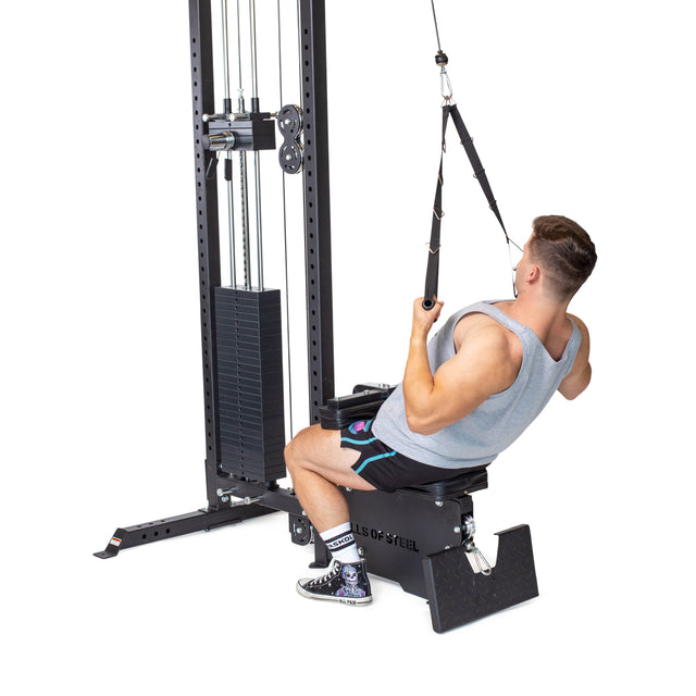 A man uses the Bells of Steel Nylon Adjustable Length Single Handle Cable Attachment on a seated row machine, pulling it toward his torso while sitting on a padded bench with his feet braced against the platform.