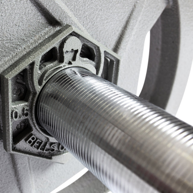 Close-up of the Bells of Steel Pro-Style Lat Bar Cable Attachment (38") inserted into a textured, gray weight plate. The shiny, grooved bar contrasts with the engraved plate—perfect for intense back workouts.