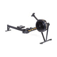 The Bells of Steel Blitz Air Rower is a stylish and functional black rowing machine with a long seat rail, fan flywheel, and footrests. Featuring yellow text on the side and set against a white background, it promises a low-impact cardio workout.