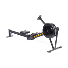 The Bells of Steel Blitz Air Rower is a stylish and functional black rowing machine with a long seat rail, fan flywheel, and footrests. Featuring yellow text on the side and set against a white background, it promises a low-impact cardio workout.