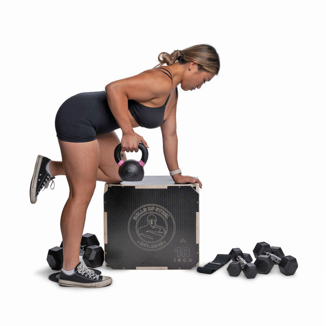 A woman in athletic wear demonstrates a bent-over row with a kettlebell from the Bells of Steel Strength Circuit Starter Kits, surrounded by versatile dumbbells and kettlebells ideal for home workouts, against a white background.
