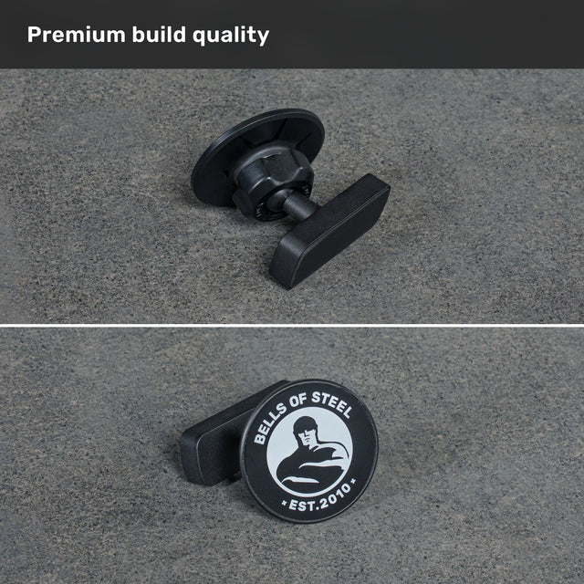 Two views of the Bells of Steel Selfie Sentinel - Magnetic Rack Phone Holder are shown in black metal with a handle, featuring the “Bells of Steel” logo and “EST. 2010” on a gray surface under the heading “Premium build quality.” This accessory effortlessly pairs with any magnetic phone mount, making it an ideal choice for those seeking durability and functionality in their gym setup.