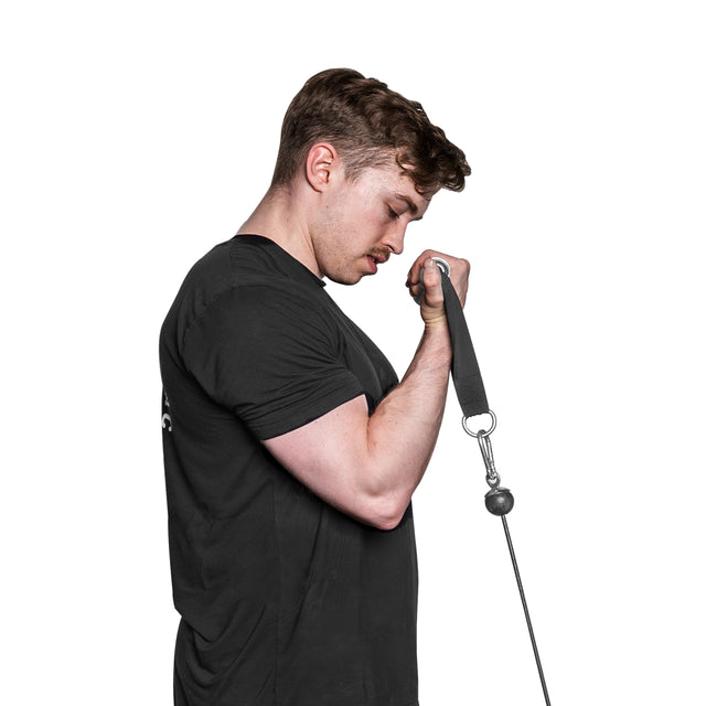 A short-haired man with a mustache uses Bells of Steel Aluminum Handles Pair with Bearings for a bicep curl. Dressed in a black T-shirt, he stands against a white background, focused intently on his workout.