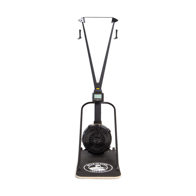 A front view of the Blitz Ski Trainer by Bells of Steel, featuring handles, a digital display, an air-powered flywheel, and a flat base with branding—designed as an indoor ski trainer for cross-country skiing workouts.