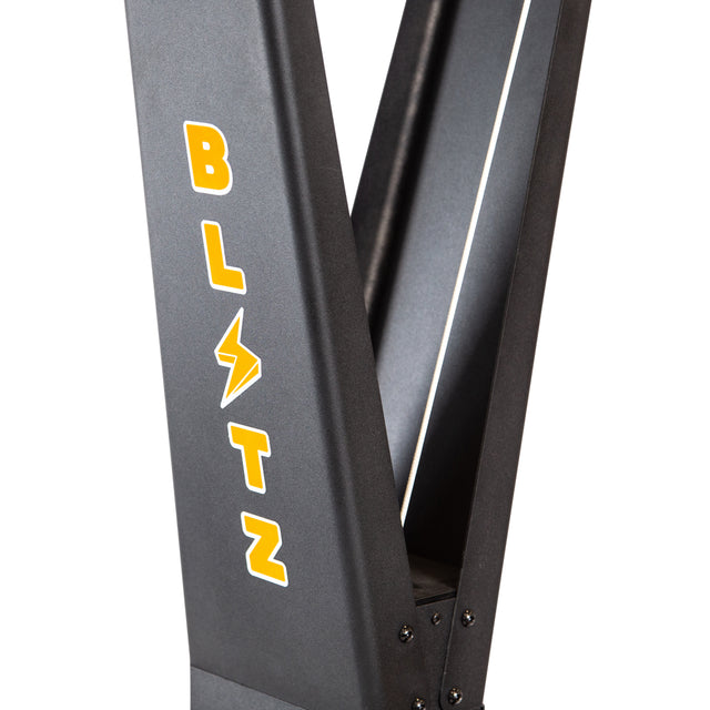 Close-up of the Bells of Steel Blitz Ski Trainer’s black metal frame, with “BLITZ” in yellow letters and a lightning bolt for the “I”—perfect for high-intensity cross-country ski workouts.