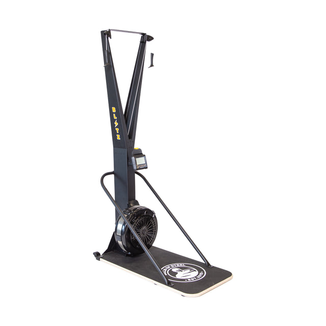 The Bells of Steel Blitz Ski Trainer is a black ski ergometer with handles, air-powered flywheel, display monitor, and “Blitz” logo platform, designed for indoor cross-country skiing workouts.