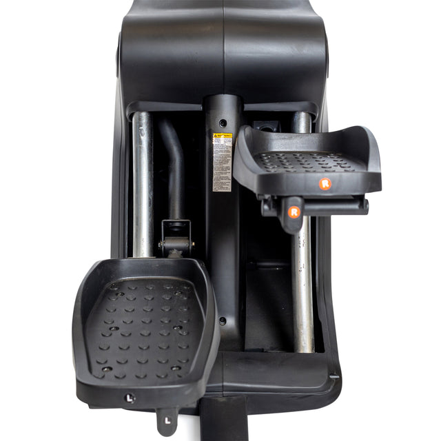 Close-up of Bells of Steel Blitz Stepper pedals, marked “L” and “R,” featuring textured footrests and sturdy metal bars—perfect for low impact cardio workouts.