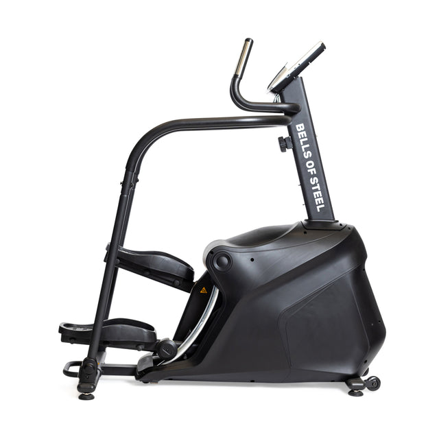 The Blitz Stepper by Bells of Steel is a black and silver stair climber with handlebars and a display screen, shown from the side on a white background—ideal for low impact cardio workouts.