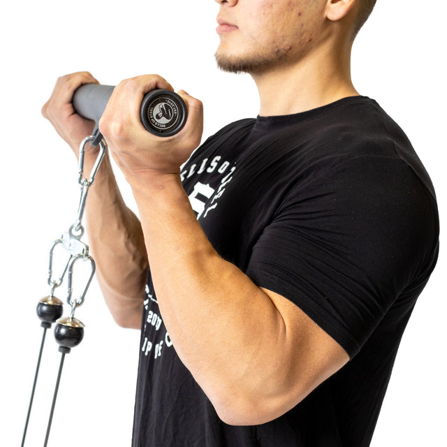 A man in a black T-shirt uses the Bells of Steel Fat Bar - Straight Handle Bar with a cable machine to perform bicep curls, boosting grip strength, isolated on a white background.