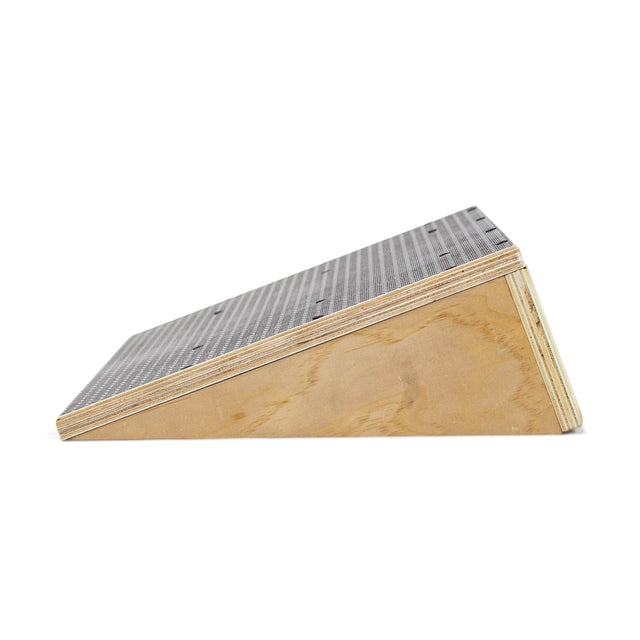 The Bells of Steel Squat Wedge Board features a textured, dark top and light wood sides, designed to enhance ankle mobility and squat depth. Shown from the side against a white background.