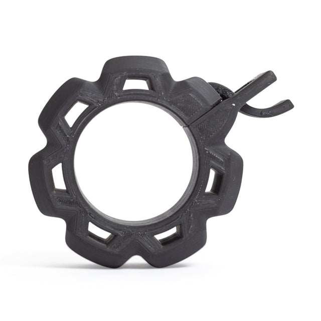 Black, gear-shaped plastic ring with a central opening, six notches, and a side latch. This item is the Bells of Steel Barbell Zip Clips - Half Standard (Pair), used to secure weight plates on barbells. Photographed on a white background.
