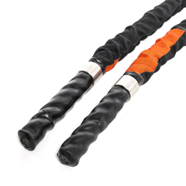 A close-up shows two Bells of Steel Battle Ropes, essential for conditioning workouts. One has orange accents and black handles, while the other features sleek black wraps. They are elegantly coiled against a white background.