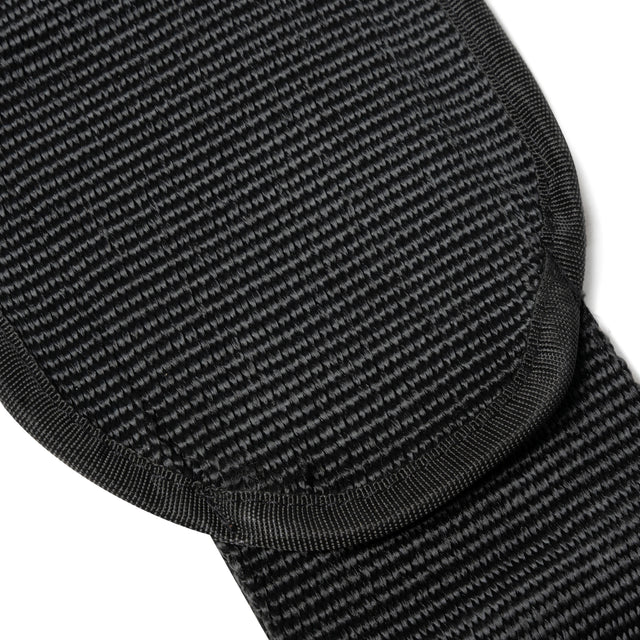 Close-up of the Bells of Steel Dip Belt reveals textured black fabric with a thick, rounded edge, featuring tightly woven material and reinforced stitching for durability.