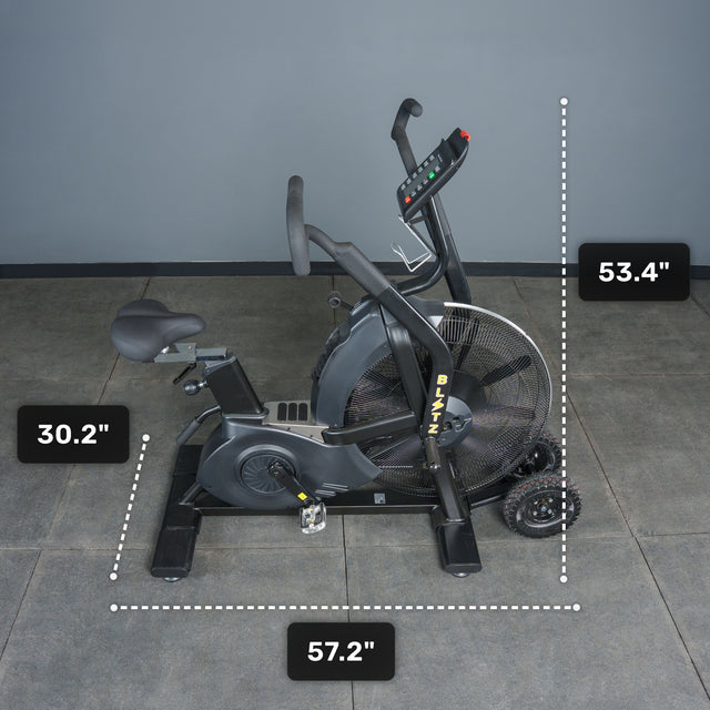 The Bells of Steel Blitz Max Air Bike, perfect for commercial gyms, features a black frame on a gray floor with dimensions: 30.2" seat height, 53.4" handlebar height, and 57.2" length—premium equipment for intense workouts.