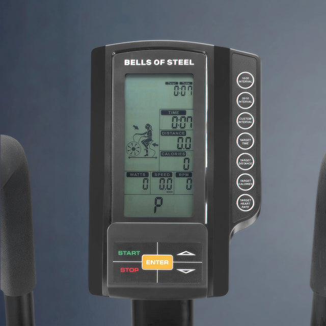 Close-up of the Bells of Steel Blitz Air Bike's digital display panel, showing workout metrics (time, distance, calories, watts, speed, and RPM) with start/stop and enter buttons below.