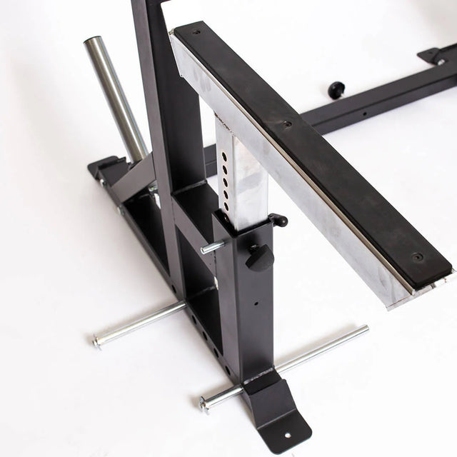Close-up of the Bells of Steel StrongArm Combo Rack – Squat Stand & Bench Press, featuring a black metal adjustable frame with a shiny silver support bar, adjustment holes, and pins on a white background.