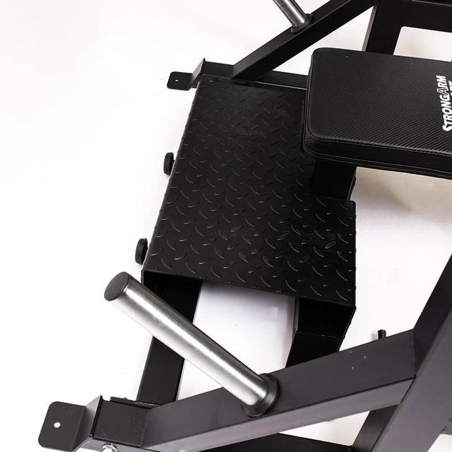 Close-up of the Bells of Steel StrongArm Combo Rack – Squat Stand & Bench Press, showing its black diamond-plate steel foot platform, padded seat, and chrome barbell holders on this versatile gym machine.