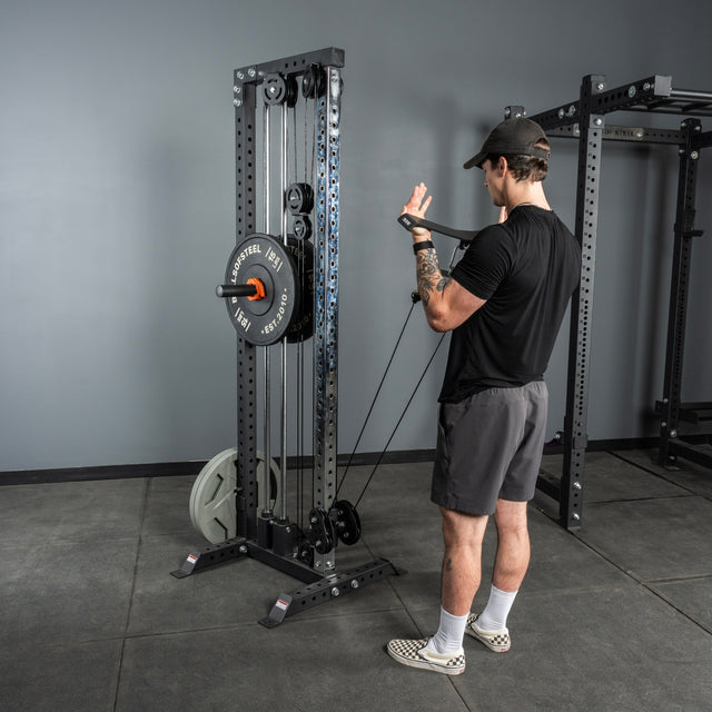 A man in a gym grips the Bells of Steel Flat-Iron Tricep Press Cable Attachment, ideal for maximizing tricep activation during strength training.