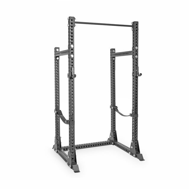 The Bells of Steel Manticore Half Rack - Prebuilt features a sturdy black 3" x 3" frame with 1" holes, safety bars, and a pull-up bar—ideal for weightlifting and strength training in your home gym.