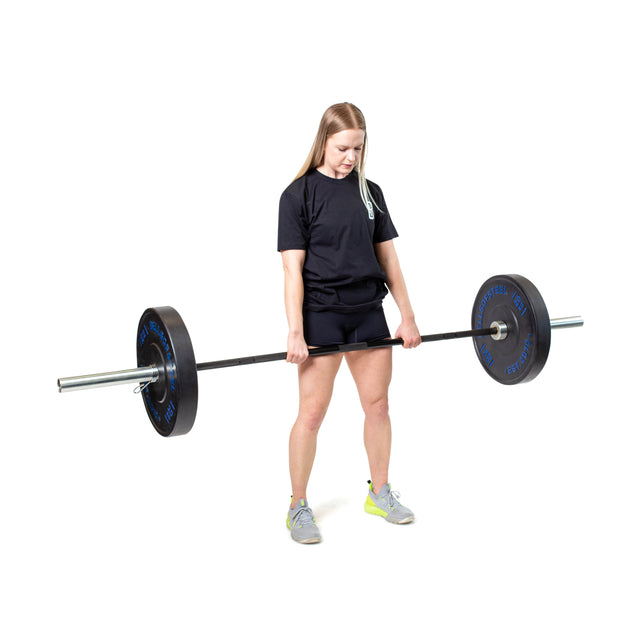 A woman wears a black T-shirt, black shorts, and gray sneakers while weightlifting a heavy barbell loaded with Bells of Steel Dead Bounce Conflict Bumper Plates made from virgin rubber against a plain white background.