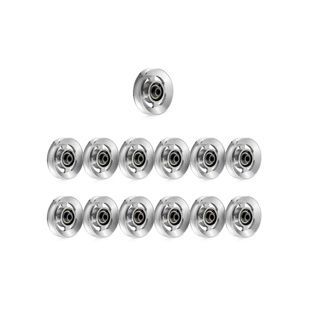 Twelve silver Aluminum Pulley Wheels from the Bells of Steel Upgrade Kit are arranged in a triangle on a white background, with one at the top and eleven below in rows.