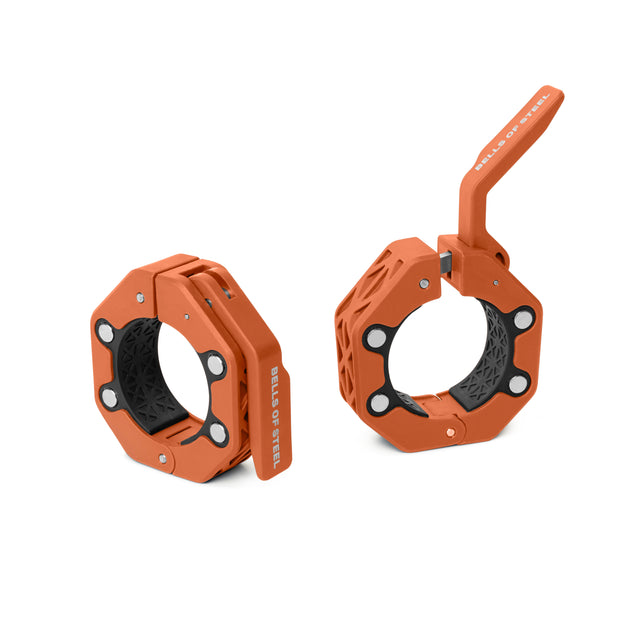 Two orange, hexagonal Magnetic Clamp Collars from Bells of Steelâone closed, one open with a raised locking leverâboth feature black textured inner grips for secure lifting and premium barbell support.