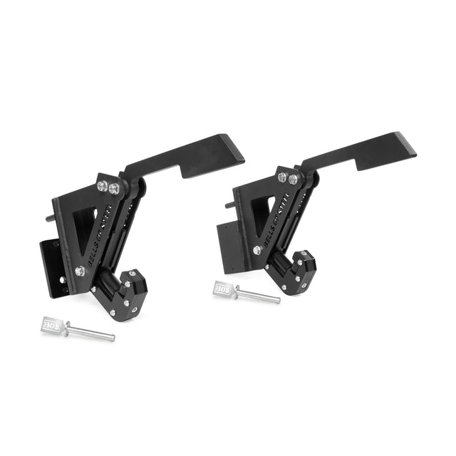 The Bells of Steel Monolift Rack Attachment features two black metal adjustable hinges with angled levers, labeled silver pins, and durable UHMW plastic parts, all in a space-saving design against a white background.