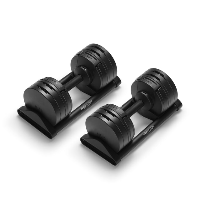 The Bells of Steel NÜOBELL-S Adjustable Dumbbells, featuring circular weight plates on sleek black stands, are ideal for any home gym and stand out against a crisp white background.