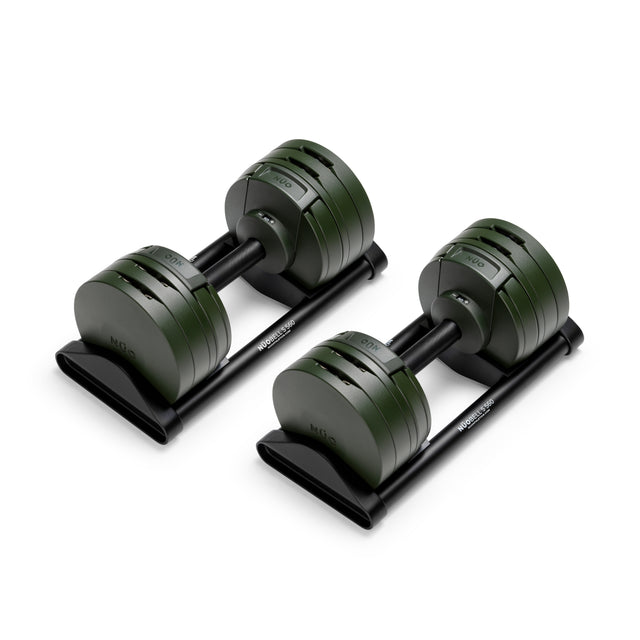 The Bells of Steel NÜOBELL-S Adjustable Dumbbells feature precision engineering and dark green plates, resting on black trays—an ideal addition to any home gym.