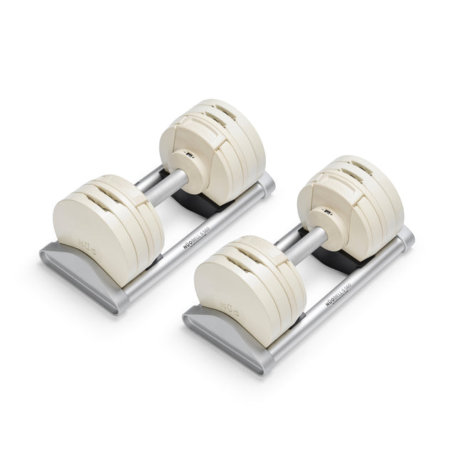 The Bells of Steel NÜOBELL-S Adjustable Dumbbells feature white weight plates and silver handles on matching trays—precision-engineered to elevate your home gym setup.