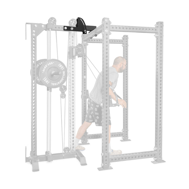 A man performs a chest fly with a black cable attachment inside a gray, worn rack, secured by the Bells of Steel 3x3 Cable Tower to Rack Connection Kit.