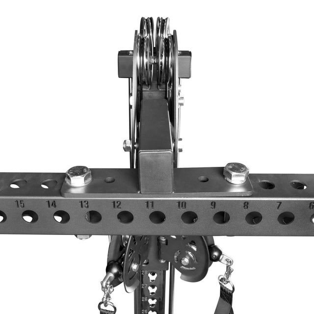 Close-up of the Bells of Steel 3x3 Cable Tower to Rack Connection Kit, showing a center-mount cable tower on a horizontal beam with numbered holes, bolts, pulley wheels, and a bracket for versatile attachment options.
