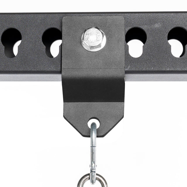 Close-up of the Bells of Steel Utility Shackle Rack Attachment, securely bolted to a perforated horizontal metal beam, with a hook suspended from the bracket—an excellent power rack accessory for any home gym attachment setup.
