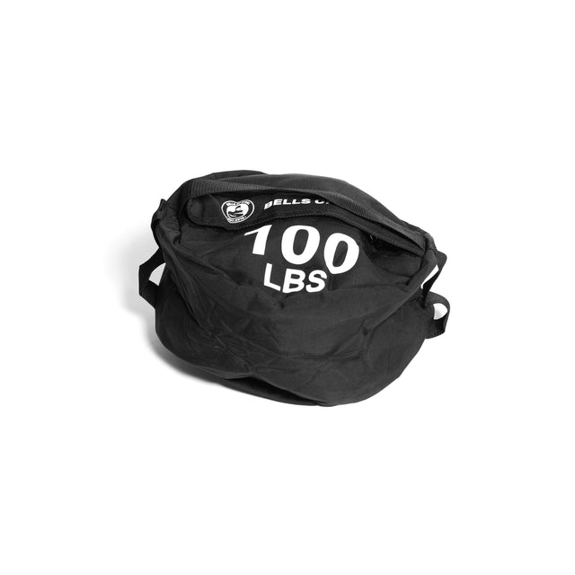 A black Bells of Steel Fitness Sandbag, designed with "100 LBS" printed on it and crafted from durable Cordura material, includes convenient side carrying handles. It is displayed against a plain white background, ideal for enhancing your sandbag workouts.