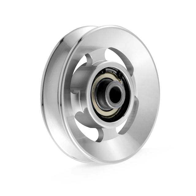 The Bells of Steel Aluminum Pulley Wheels feature a polished silver finish with a central bearing and sleek circular design, showcasing multiple cut-outs for a modern look. Isolated on a plain white background, this wheel is ideal for upgrading your cable machine.