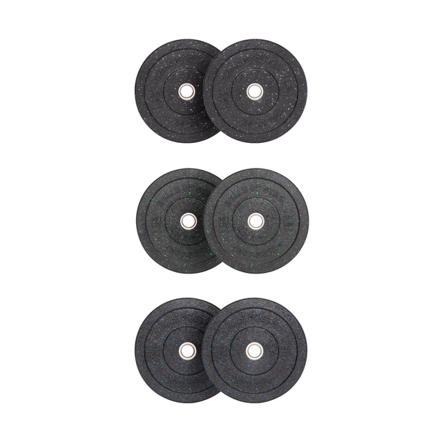 Vertical stacks of three black Bells of Steel Crumb Bumper Plates each have a stainless steel insert ring. Their speckled patterns offer uniqueness while maintaining identical design, adding aesthetic appeal and durability for weightlifting.