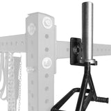 A close-up of the Bells of Steel Hanging Barbell Holders mounted on a steel gym rack, with a black handle partially visible and the rack and background faded to highlight this storage accessory.