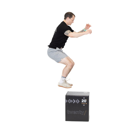 A male model jumping over the Small Foam Plyo Box 