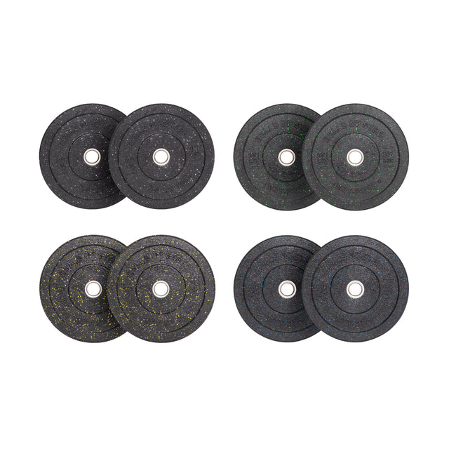 Four pairs of Bells of Steel Crumb Bumper Plates come in speckled black with white, green, yellow, and blue designs. Each pair has a stainless steel insert ring for attaching to a barbell, symmetrically displayed on a white background.