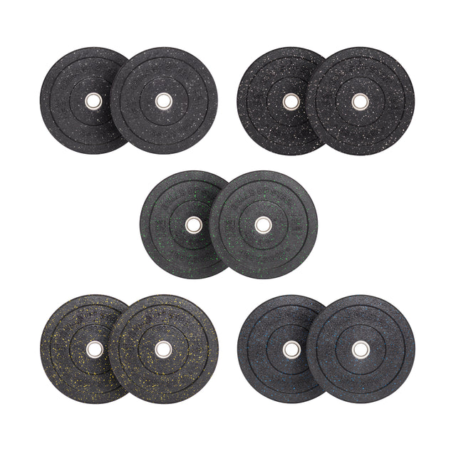 Seven pairs of black Crumb Bumper Plates by Bells of Steel, with white, gold, green, and blue speckles. Each pair has a central hole with a stainless steel insert ring for easy barbell attachment, neatly arranged in three rows against a pristine white background.