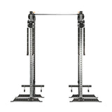 The Cable Tower Squat Stands by Bells of Steel features adjustable pulleys, a pull-up bar, and a sturdy squat stand. Made from durable metal with a sleek silver and black finish, it's perfect for versatile strength training in your home gym or fitness center.