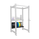 The Bells of Steel Storage Shelves feature a gray rack holding weight plates, kettlebells, and a foam roller, with colorful equipment neatly organized on the sturdy shelves.