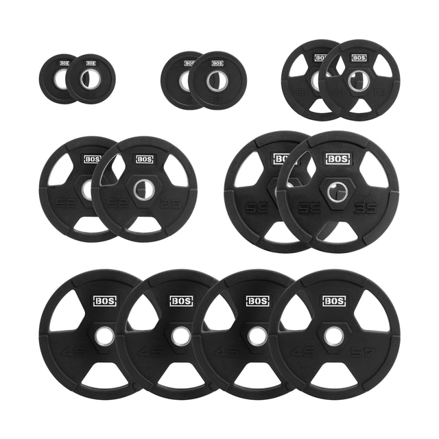 A collection of Rubber Coated Iron Weight Plates by Bells of Steel Canada, featuring ergonomic handles and stainless steel hubs, arranged in rows. Each black plate includes a central hole and the brand logo, with available weights of 2.5, 5, 10, 25, and 45 lbs. The round plates are designed with angular cutouts for easy gripping.