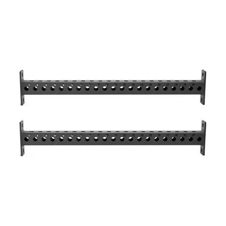 The Bells of Steel Manticore Crossmembers consist of two parallel black metal bars with evenly spaced holes, designed to be compatible with multiple rack attachments. Each bar is equipped with a vertical flat plate at both ends for secure mounting or support, set against a plain white background.