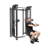 A person is using a Kraken Rack Attachment for 4 Post Hydra & Manticore Racks by Bells of Steel in the gym. This dual-handle cable tower includes pulleys and adjustable weights. They are seated on an adjustable bench, pulling cables toward their body with intense focus.