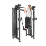 A person at the gym is using the Kraken Rack Attachment for 4 Post Hydra & Manticore Racks by Bells of Steel, utilizing its dual-handle functionality and the weight-assisted platform within its power rack-like metal frame.