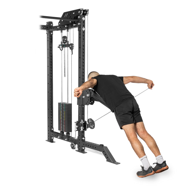 A person uses a Bells of Steel Kraken Rack Attachment for 4 Post Hydra & Manticore Racks (Single Side), leaning forward to pull a rope attachment. They're dressed in a black shirt, black shorts, white socks, and black shoes.