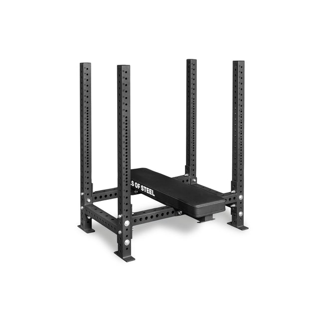 The Bells of Steel Four Post Converter Bench is a heavy-duty black steel bench with padding and upright supports, featuring multiple holes for adjustable barbell placement—ideal for any powerlifting gym.