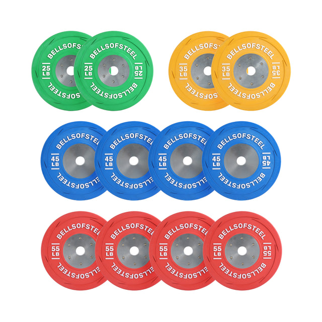 Image showcasing Bells of Steel LB Competition Bumper Plates for Olympic lifting. The set includes four 25 lb green plates, four 45 lb yellow plates, and six 55 lb red plates, all expertly arranged in three horizontal rows by color and weight.